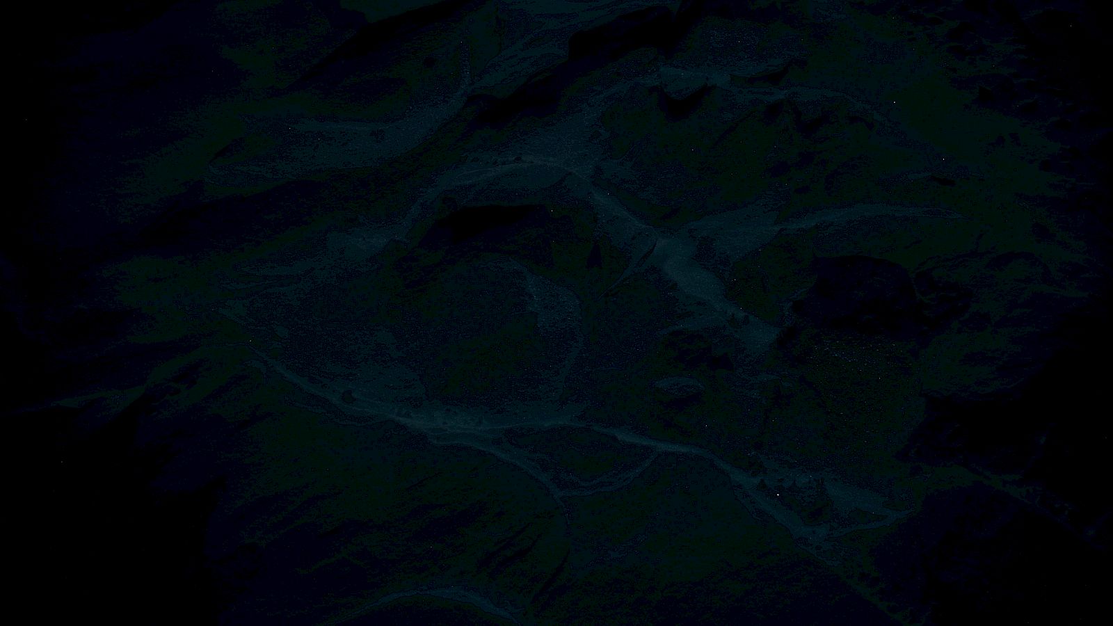 The image is too dark to discern any clear details or subject matter.